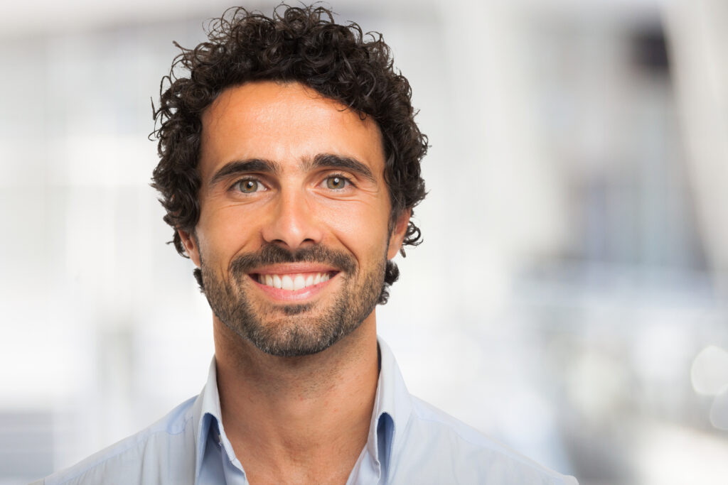 a man smiling with dental implants.